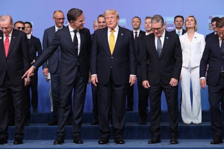 Mark Rutte smiles and points to something out of shot