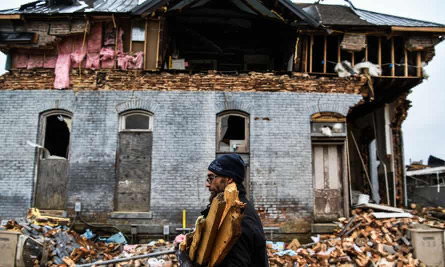 A man clears debris outside his destroyed house in Mayfield, Kentucky, on 16 December.