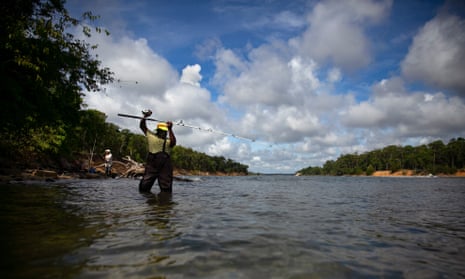 A person fishes in the Cape Fear River 30 June 2022, in Wilmington, North Carolina. The consequences of the EPA’s narrower definition have already been felt in North Carolina’s Cape Fear basin, which is contending with decades of Chemours pollution. 