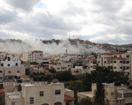 Smoke rises over a cityscape