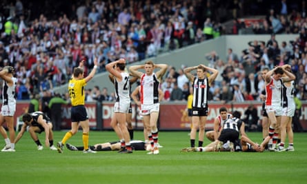St Kilda and Collingwood players stand with their hands on their head after the 2010 AFL grand final ended in a draw
