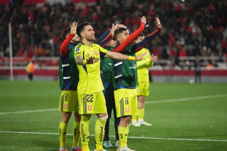 Players of Universidad de Chile try to calm down their fans.
