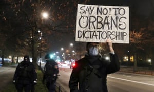 A man protesting in Hungary as Viktor Orbán and Polish prime minister Mateusz Morawiecki meet.