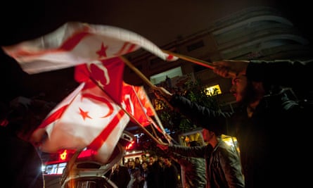Protesters shout wave Turkish and Turkish Cypriot flags during a demonstration against Afrika in Nicosia.