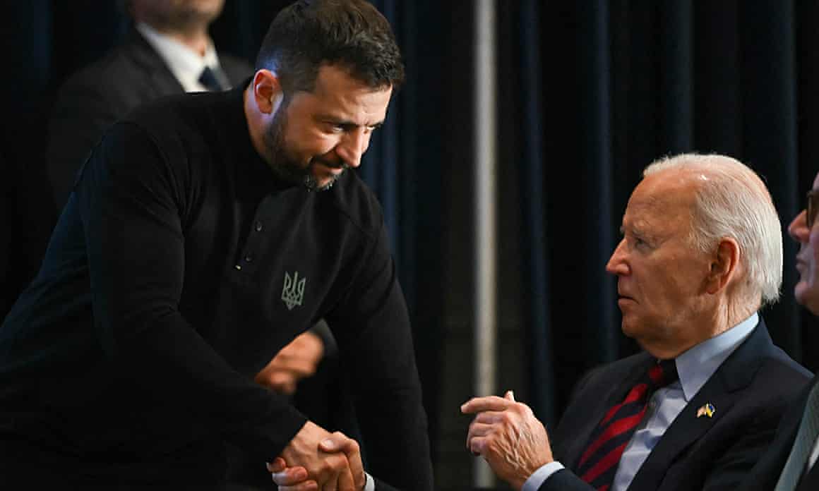 The Ukrainian president, Volodymyr Zelenskyy, shakes hands with Joe Biden.