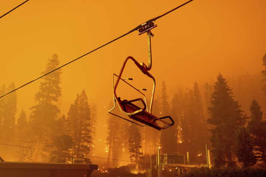 The Caldor fire burns as a chairlift sits motionless at the Sierra-at-Tahoe ski resort in August.