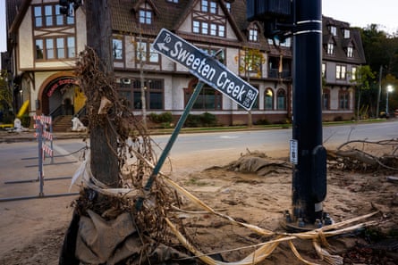 a destroyed street sign that says “Sweeten Creek”