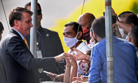 Brazil’s president Jair Bolsonaro greets supporters in Brasilia, on April 13, 2021