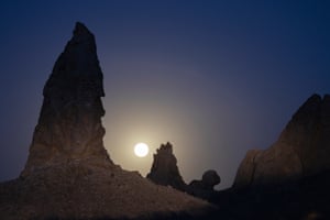 The strawberry supermoon sets behind the Trona Pinnacles, California, US, which were formed underwater when this region of the Mojave Desert was under a body of water
