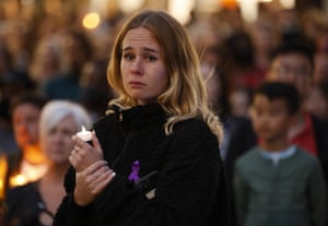 A woman cries as she attends a vigil.