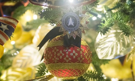 A space force ornament hangs from a tree in the East Room at the White House in Washington.