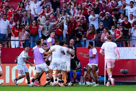 Sevilla celebrate José Ángel Carmona’s late strike.
