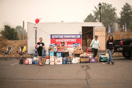 A donation drop-off and pick-up station set up by volunteers is seen at an evacuation site in the parking lot of the Clackamas Town Center in Happy Valley, Oregon, on September 11, 2020. -