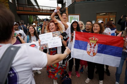 Novak Djokovic fans celebrate after his victory over Andrey Rublev.