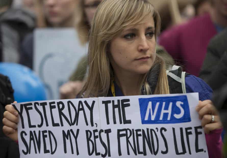 Protester holds a placard at a demonstration in support of junior doctors in London