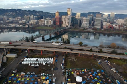 In this aerial photo, tents housing people experiencing homelessness are set up on a vacant parking lot in Portland,