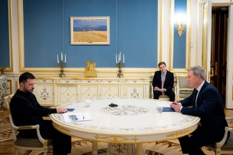 Ukraine's President Volodymyr Zelenskyy (L) looks on during a meeting with US Secretary of the Army Daniel Driscoll (R) in Kyiv.