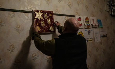 Borden arranges Christmas decorations brought by volunteers in his base near the frontline in Donbas
