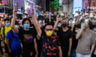 Hong Kong protests: arrests as thousands sing protest anthem on anniversary of clashes