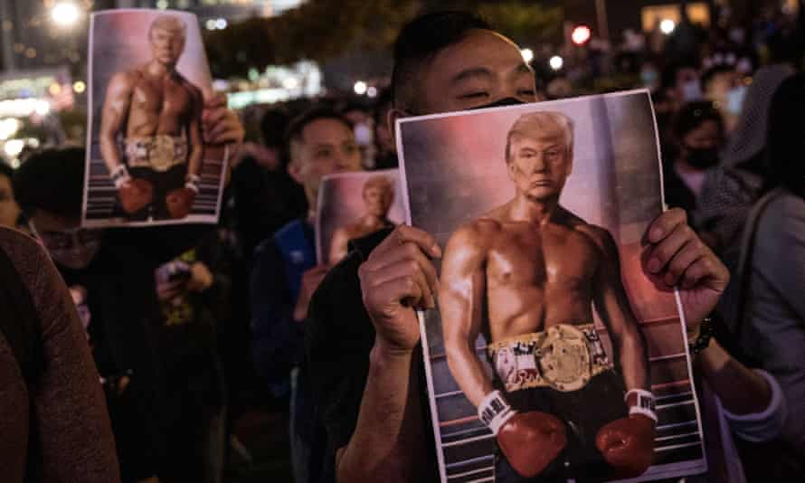 Protesters hold posters of US president Donald Trump during a Thanksgiving Day rally.