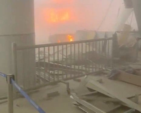 Debris litters the ground while fires rage at the airport