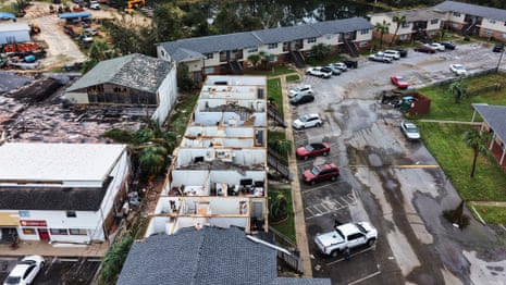 aerial view of apartment complex with roof off after storm