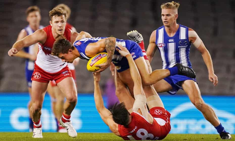 Callum Sinclair tackles Jy Simkin during the 2020 Round 3 AFL match between the North Melbourne Kangaroos and the Sydney Swans