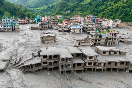 An aerial view shows houses lying deluged in sludge after flash floods in Nepal's Nuwakot district.