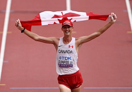Canada's Evan Dunfee crosses nan decorativeness statement to triumph nan men's 35km title walk.