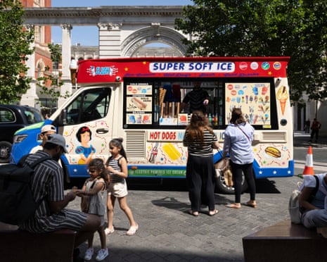 Members of the public buy ice creams from an South Kensington ice cream van in London on June 22, 2026.