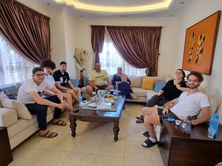 Adam Bassam and his family sitting in their family home
