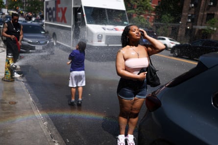 People cool off at a fire hydrant