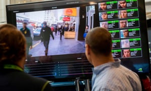 A display shows a facial recognition system for law enforcement during a technology conference.
