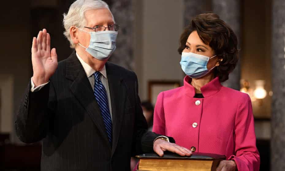 Senate majority leader Mitch McConnell participates in a swearing-in for the 117th Congress, as his wife, Transportation Secretary Elaine Chao, holds the Bible in the Capitol on Sunday.