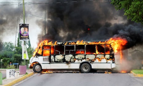 A burning bus, set alight by cartel gunmen to block a road, in Culiacan, Sinaloa state, Mexico on Thursday. 