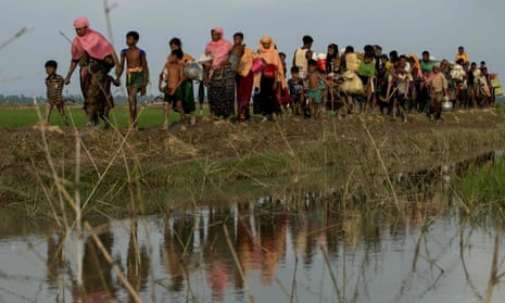 Displaced Rohingya refugees from Rakhine state carry their belongings near the border between Bangladesh and Myanmar.