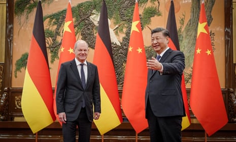 Xi Jinping gestures as he welcomes Olaf Scholz in Beijing on Friday