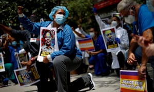 Members of the 1199SEIU union, the nation’s largest healthcare workers’ union, kneel for eight minutes and 46 seconds, during a vigil.