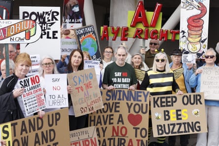 protestors hold up signs
