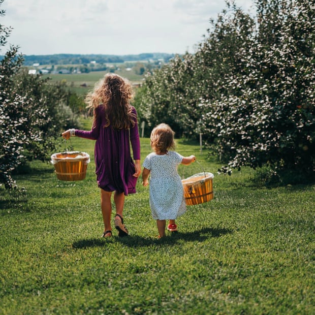A woman and child gather cider apples