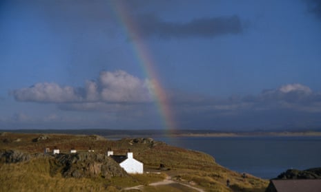 a small cottage in Wale with rainbow