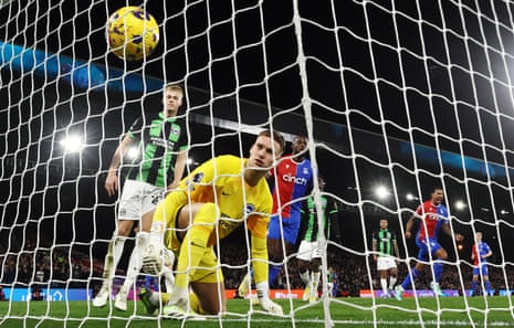 Brighton goalkeeper Bart Verbruggen looks on as Jordan Ayew scores Crystal Palace's first goal.