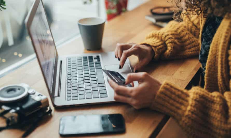 Woman in cafe shopping online with laptop