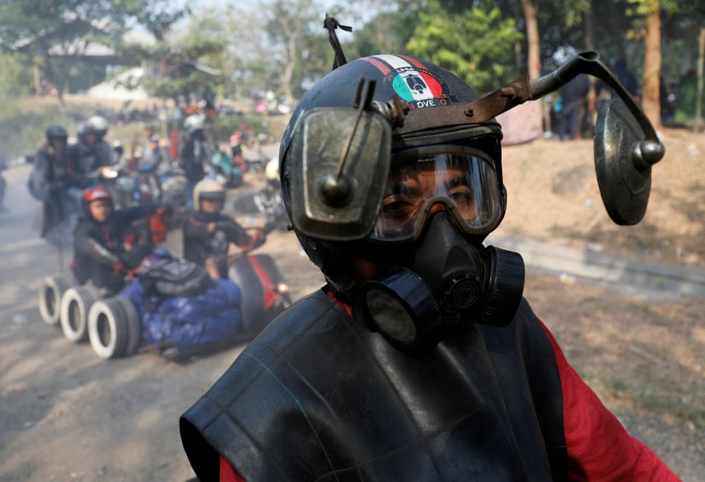 A rider wears a modified helmet and mask | The Guardian