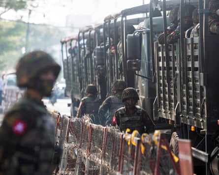Soldiers in military vehicles in Yangon, Myanmar. The army has detained almost 30,000 people since the 2021 coup.