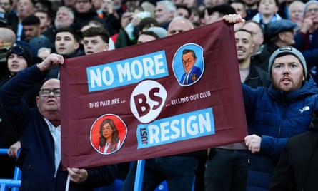 West Ham fans hold up a banner showing caricatures of Karren Brady and David Sullivan