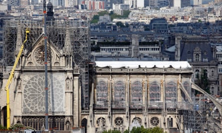 Temporary tarpaulins cover the roof of the cathedral to protect it from rain damage.
