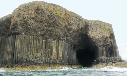 Exterior of Fingal’s Cave, Scotland, as seen from a boat looking towards shore.