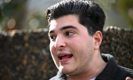Head shot of man wearing black speaking to media