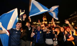 Scotland fans celebrate the result in Glasgow.